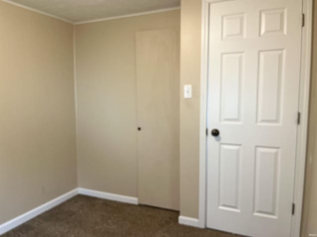 7374 W Upper Bensart Dr, Claypool, IN 46510 - unfurnished bedroom with dark carpet, baseboards, and ornamental molding
