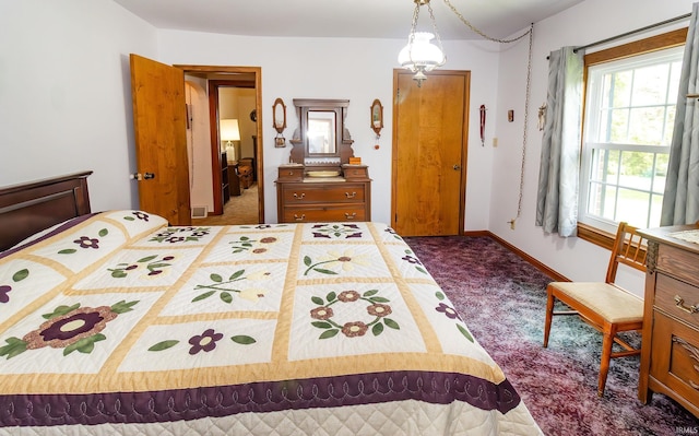 carpeted bedroom featuring baseboards