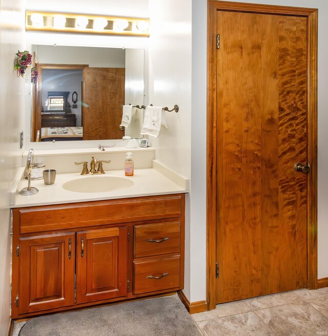 bathroom featuring vanity and baseboards