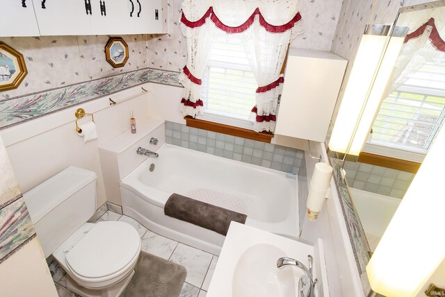 bathroom with toilet and a bath