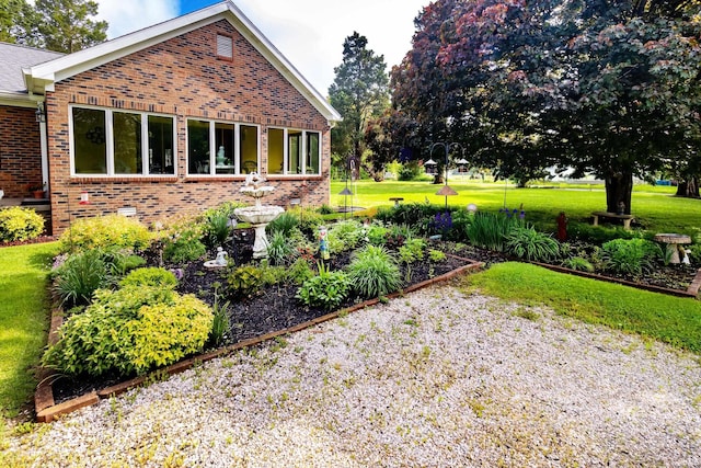 view of property exterior with brick siding and a lawn