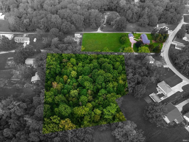 aerial overview of property's location featuring a heavily wooded area and property parcel outlined