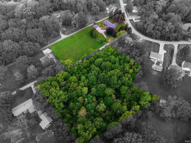 view of property location with property boundaries highlighted and a heavily wooded area