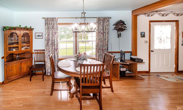 dining space with a chandelier and light wood-style floors