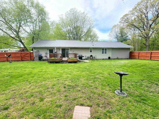 back of property featuring a wooden deck and metal roof