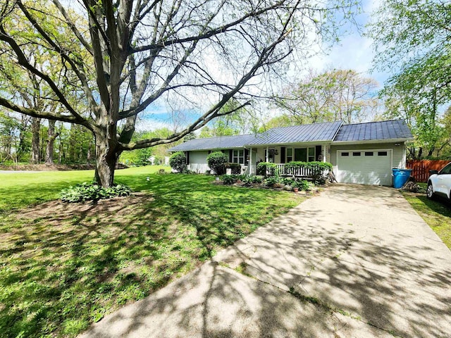 ranch-style home with a porch, an attached garage, concrete driveway, and metal roof