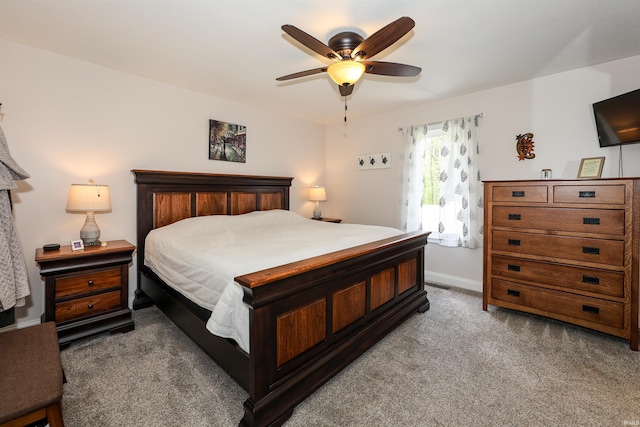 carpeted bedroom featuring ceiling fan and baseboards