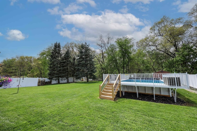 view of yard with a deck, stairway, and view of scattered trees