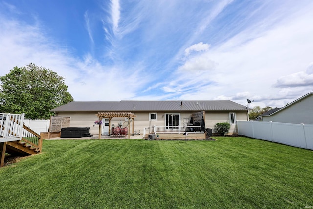 back of property featuring a hot tub, a pergola, and a patio