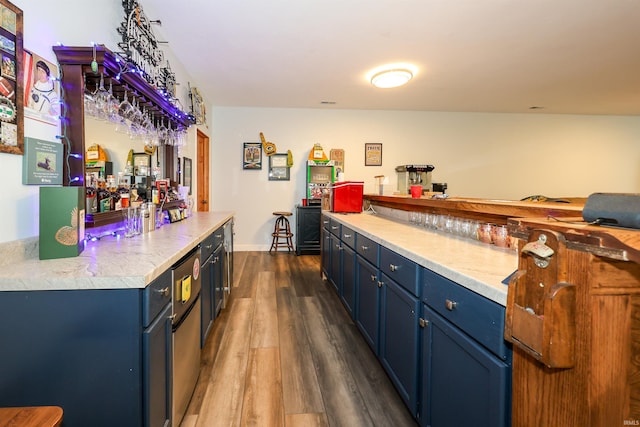 indoor dry bar featuring dark wood-type flooring
