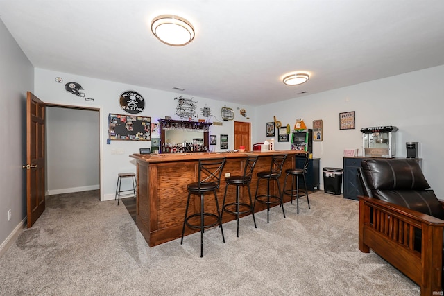 indoor dry bar with light carpet and baseboards