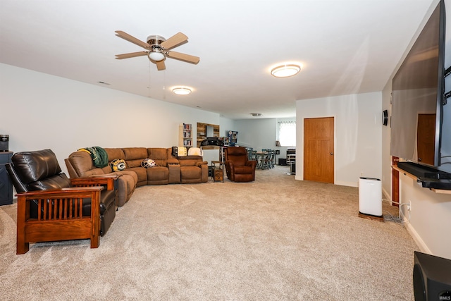 living room with carpet flooring, a ceiling fan, and baseboards