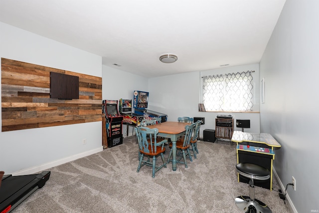carpeted dining space featuring baseboards