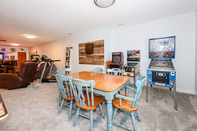 carpeted dining area with baseboards