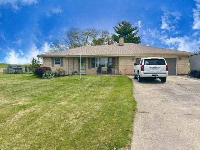 52 S 950 E, Greentown, IN 46936 - single story home with concrete driveway, a front yard, brick siding, and a chimney