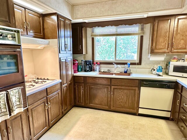 52 S 950 E, Greentown, IN 46936 - kitchen featuring white appliances, a sink, light countertops, and light tile patterned floors