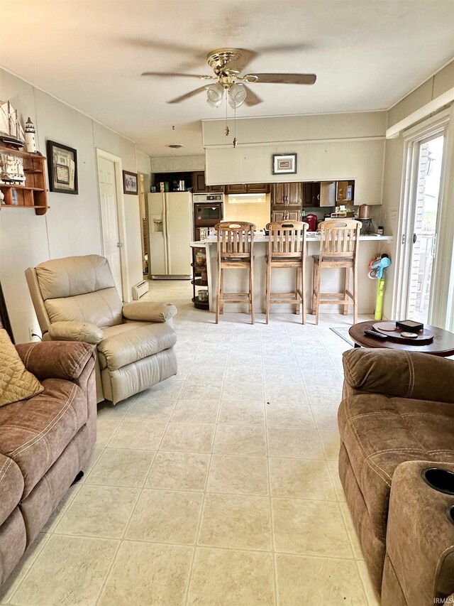 52 S 950 E, Greentown, IN 46936 - tiled living area featuring a ceiling fan and a baseboard radiator
