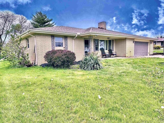 52 S 950 E, Greentown, IN 46936 - ranch-style home featuring a chimney, a garage, a front yard, and brick siding