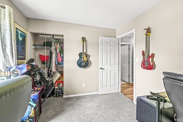 carpeted bedroom with a closet and baseboards