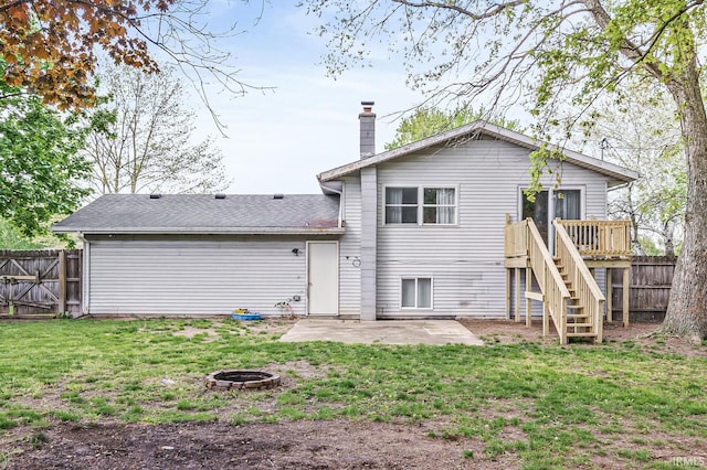 rear view of property with a fire pit, a patio area, stairway, a wooden deck, and a chimney
