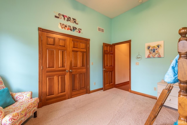 bedroom featuring carpet flooring, a high ceiling, and baseboards