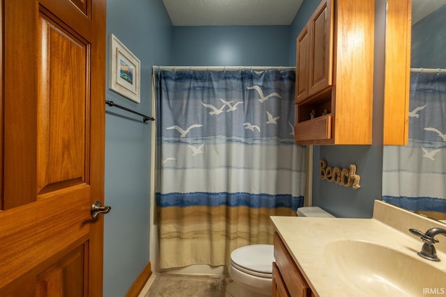 bathroom featuring toilet, vanity, and tile patterned floors