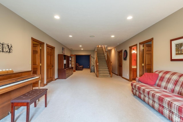 living area featuring light colored carpet, recessed lighting, stairs, and baseboards