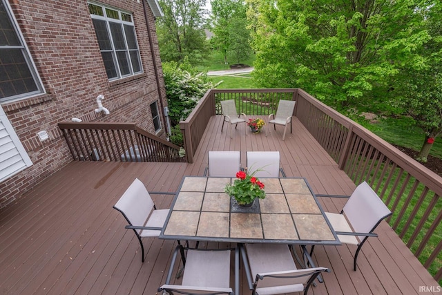wooden terrace with outdoor dining space
