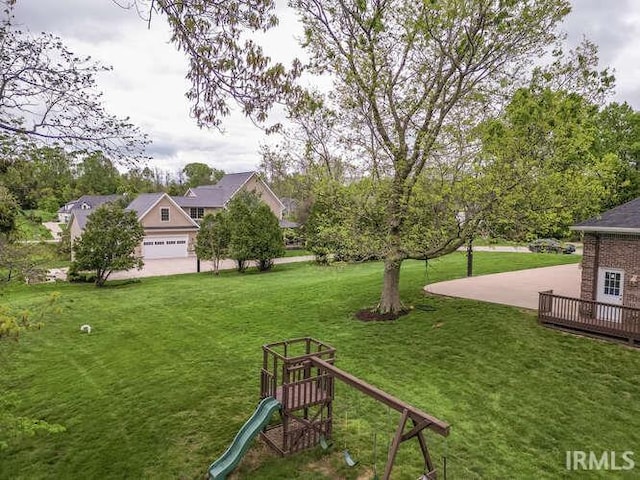 view of green lawn featuring a playground