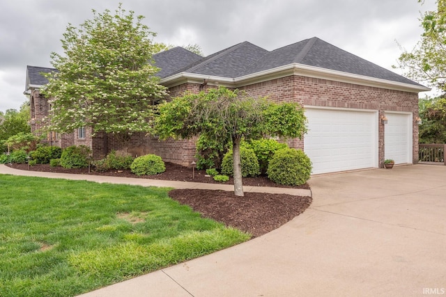 view of front of house featuring brick siding, driveway, roof with shingles, and a garage
