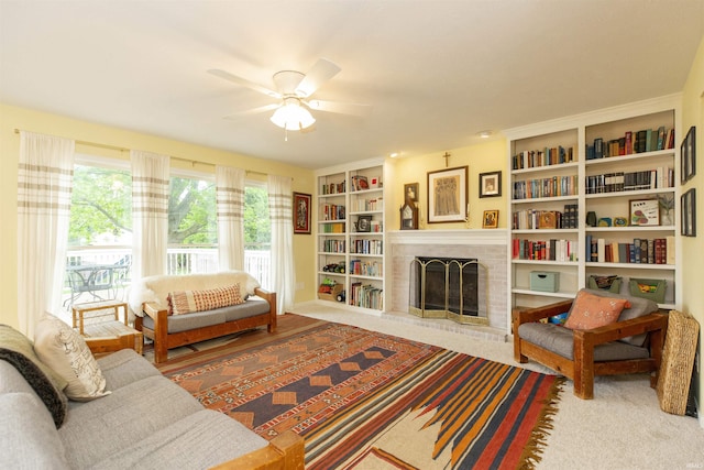 14375 Pheasant Ct, Mishawaka, IN 46545 - living area with ceiling fan, a brick fireplace, built in shelves, and carpet flooring