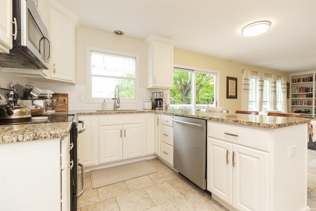 14375 Pheasant Ct, Mishawaka, IN 46545 - kitchen with appliances with stainless steel finishes, a peninsula, a sink, backsplash, and white cabinets