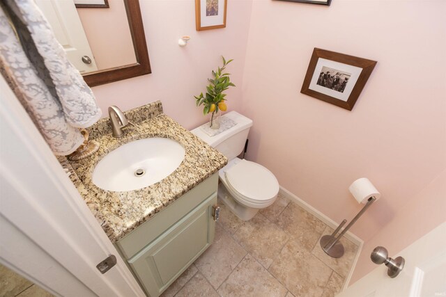 14375 Pheasant Ct, Mishawaka, IN 46545 - bathroom with vanity, toilet, baseboards, and stone finish flooring