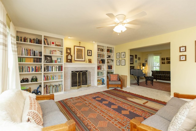 14375 Pheasant Ct, Mishawaka, IN 46545 - living area featuring ceiling fan, a fireplace, built in shelves, and carpet