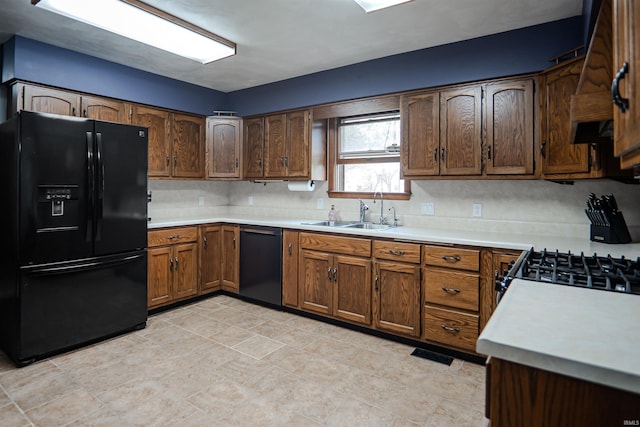 3029 Carroll Rd, Fort Wayne, IN 46818 - kitchen with black appliances, a sink, light countertops, and decorative backsplash