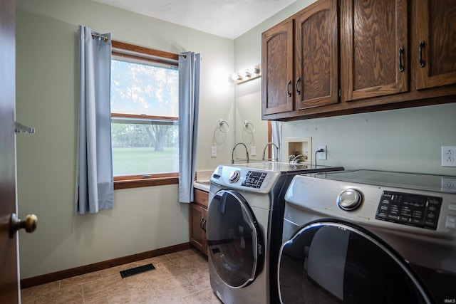 3029 Carroll Rd, Fort Wayne, IN 46818 - washroom with baseboards, washing machine and clothes dryer, cabinet space, and light stone finish flooring