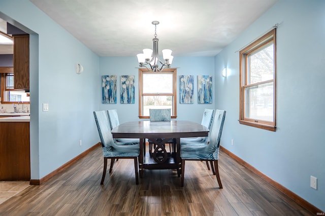 3029 Carroll Rd, Fort Wayne, IN 46818 - dining space featuring a chandelier, dark wood finished floors, and baseboards