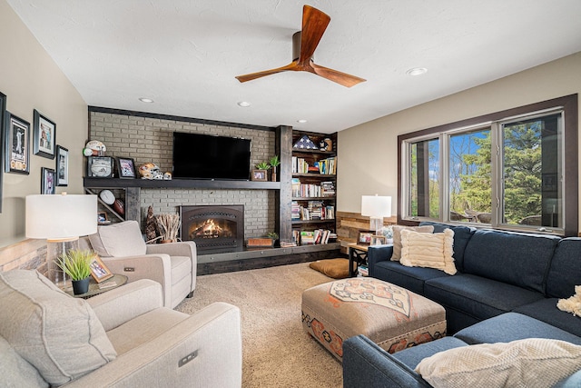 living area featuring carpet floors, a brick fireplace, a ceiling fan, and recessed lighting