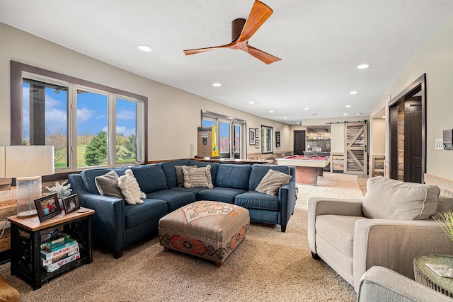 living room with recessed lighting, light colored carpet, and a ceiling fan