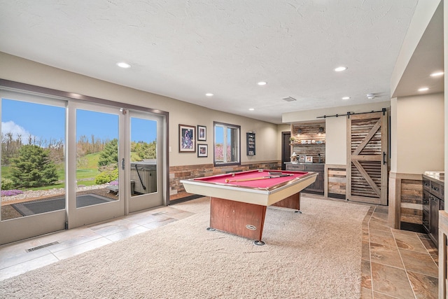 playroom with a barn door, recessed lighting, billiards, wainscoting, and a textured ceiling