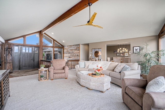 living area with a chandelier, beamed ceiling, carpet floors, a ceiling fan, and high vaulted ceiling