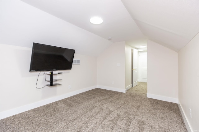 bonus room with carpet floors, lofted ceiling, and baseboards