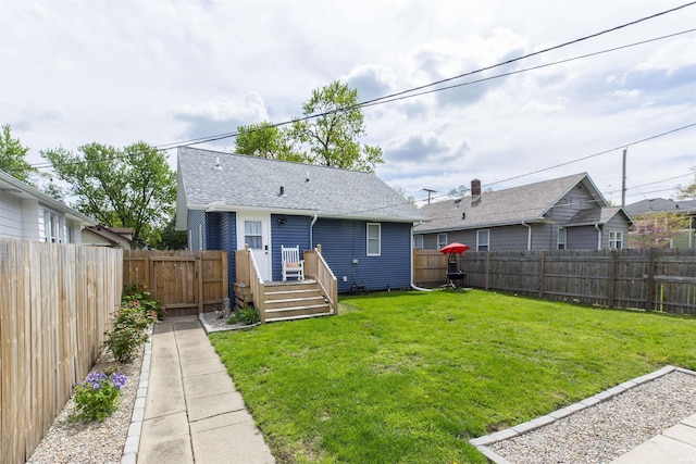 rear view of house with a deck and a shingled roof