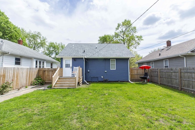 rear view of property with a shingled roof