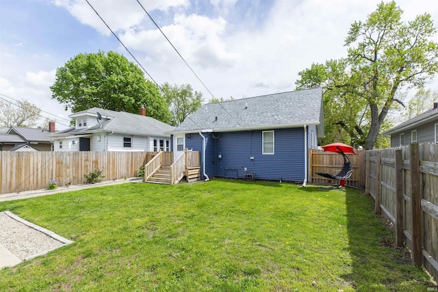rear view of property featuring a shingled roof