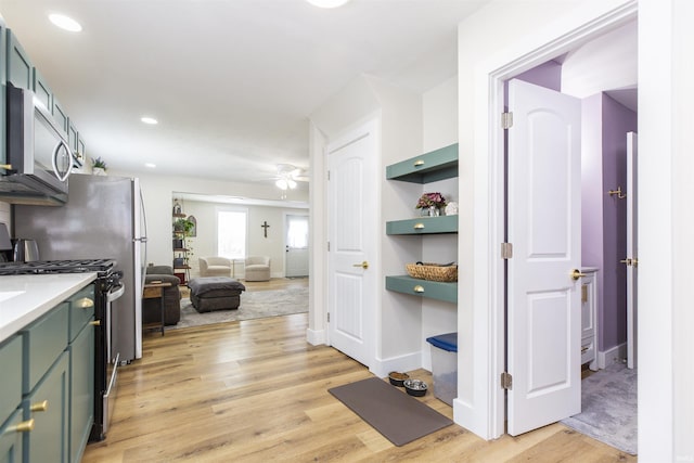 hall featuring light wood-type flooring and recessed lighting