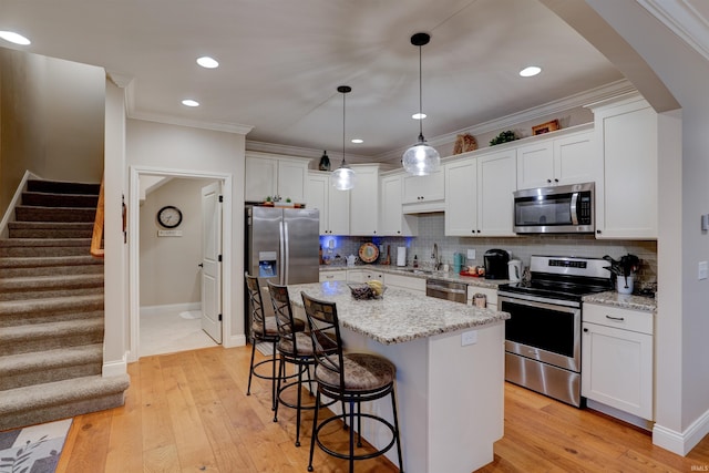 8455 Nolia Ln, Newburgh, IN 47630 - kitchen with stainless steel appliances, a sink, a breakfast bar area, white cabinets, and backsplash