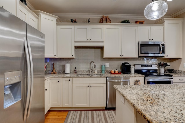 8455 Nolia Ln, Newburgh, IN 47630 - kitchen with stainless steel appliances, a sink, crown molding, white cabinetry, and light wood-style flooring