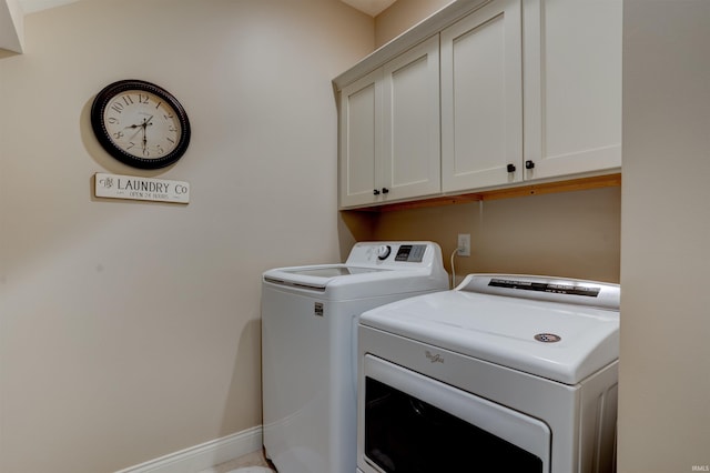 8455 Nolia Ln, Newburgh, IN 47630 - clothes washing area featuring washing machine and clothes dryer and cabinet space