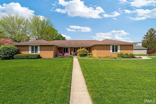 ranch-style house featuring a front yard, brick siding, and a porch